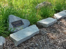 A grave marker in the Meadows of St. Kateri, the natural burial section at St. Michael the Archangel Cemetery in the Archdiocese of Chicago