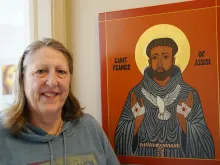 Kathleen Bordo Crombie stands next to an icon of St. Francis of Assisi, dedicated to her late husband, Robyn. The Church of the Divine Child in Dearborn, Michigan, parishioner took up iconography after taking a class at the Sacred Art Institute of St. Edmund’s Retreat Center on Enders Island in Mystic, Connecticut, where she learned iconography is rooted in depicting the image of God.