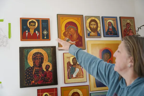 Kathleen Crombie displays samples of her work in her home office, including one of Blessed Carlo Acutis, with Carlo depicted as wearing sunglasses and the Wi-Fi symbol to the left of the icon. Credit: Daniel Meloy/Detroit Catholic
