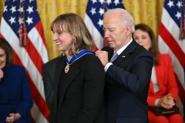 President Joe Biden awards the Medal of Freedom to U.S. Olympic gold medal swimmer Katie Ledecky during a ceremony in the East Room of the White House on May 3, 2024. Credit: Andrew Caballero-Reynolds/AFP via Getty Images