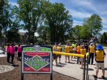 Knights from several councils in Michigan join athletes from the Challenger Division of Clinton Valley Little League, which serves people with disabilities, for the June 15, 2024, dedication of McGivney Field, a new accessible baseball diamond at Neil Reid Park in Clinton Township.