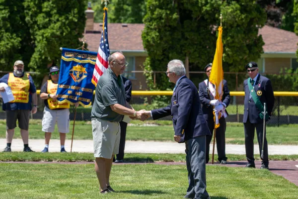 Ken Dumais of St. Mary of the Hills Council 13950 in Rochester Hills greets Michigan State Secretary Charles McCuen at the dedication of the new McGivney Field on June 15, 2024. More than 40 K of C councils donated more than $60,000 to build the field; Dumais led those efforts. Credit: Jonathan Francis