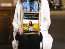Kathleen Anderson holds a photo of the woman whose heart was donated and transplanted into her. Anderson still keeps in contact with the woman’s family.