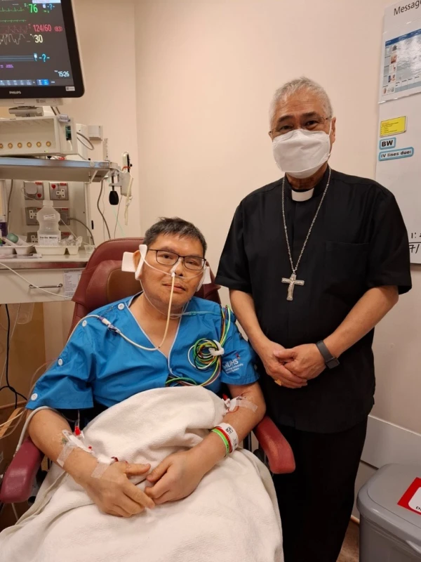 Cardinal William Goh visits Father Christopher Lee, parish priest of St. Joseph Church in the west-central Singapore region of Bukit Timah who was stabbed while celebrating Mass on Saturday, Nov. 9, 2024, in the hospital where Lee is recovering. In a Nov. 10 letter, Goh urged prayers for Lee’s recovery and also prayers for his assailant. Credit: Archdiocese of Singapore