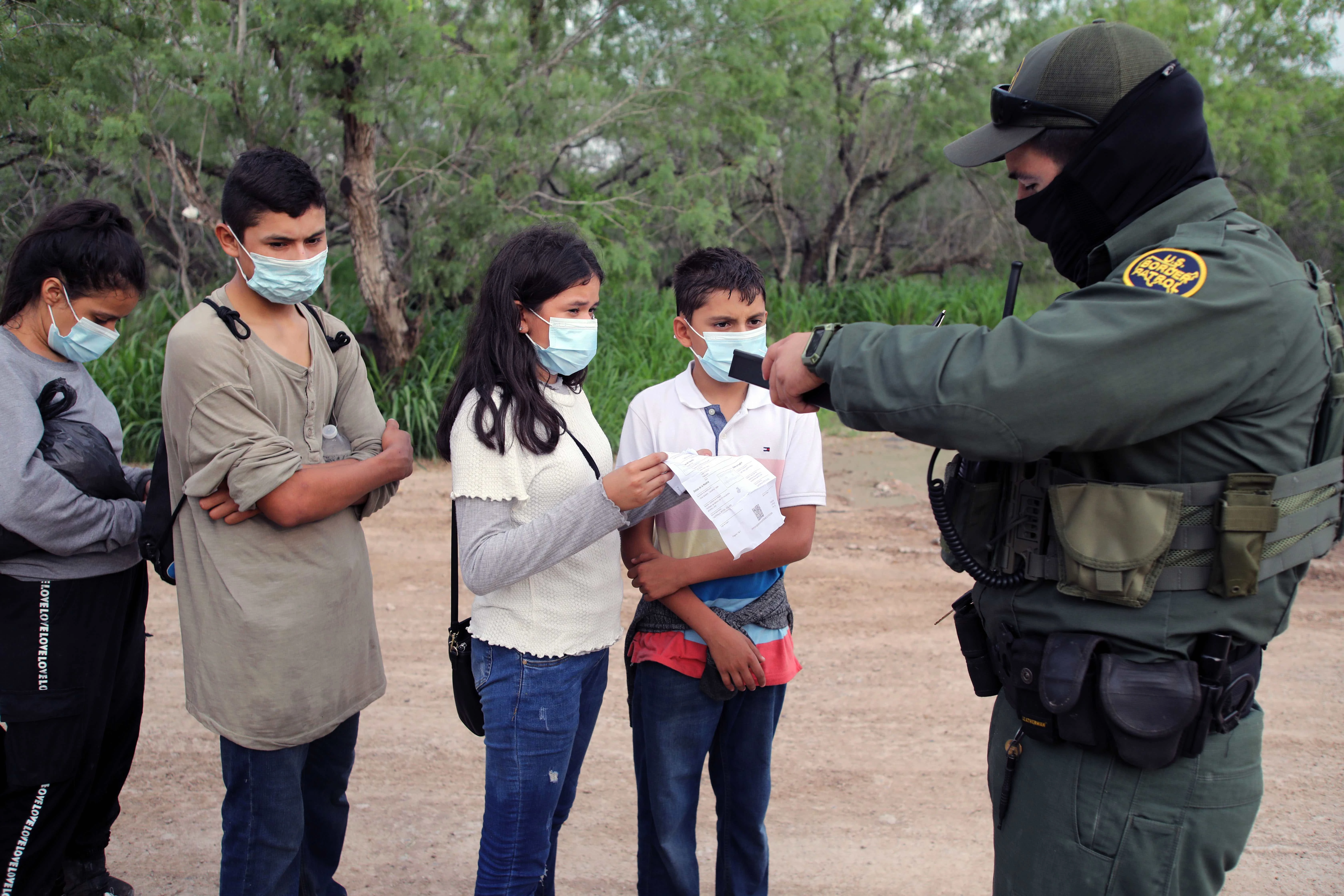 A Border Patrol agent processes a group of unaccompanied Central American minors who crossed the Rio Grande River on May 26, 2021.?w=200&h=150