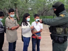 A Border Patrol agent processes a group of unaccompanied Central American minors who crossed the Rio Grande River on May 26, 2021.