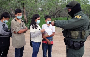 A Border Patrol agent processes a group of unaccompanied Central American minors who crossed the Rio Grande River on May 26, 2021. Credit: Vic Hinterlang/Shutterstock