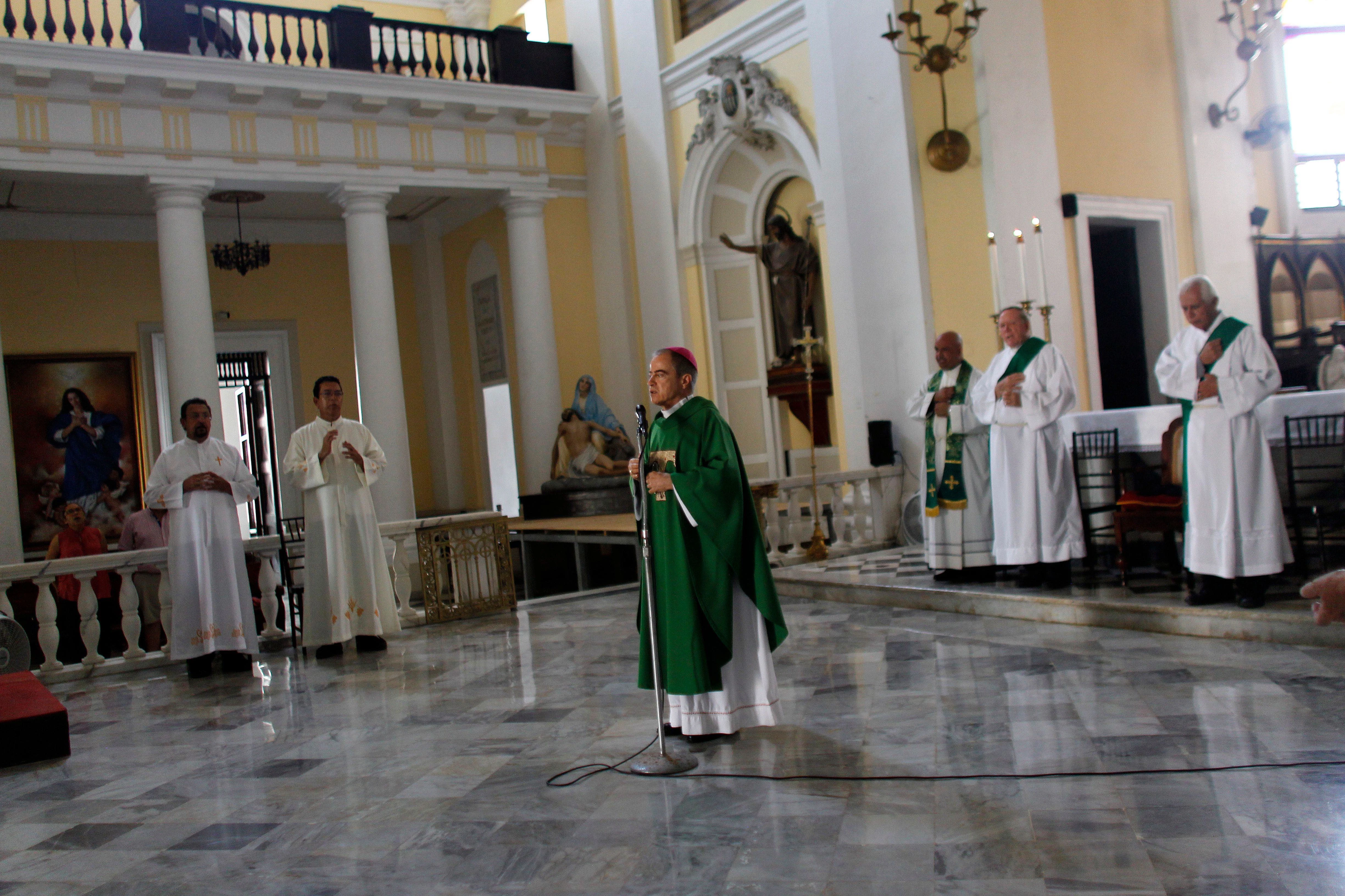 Archbishop Roberto Gonzalez prays with other priests during Sunday Mass in the San Juan Cathedral in San Juan, Puerto Rico, on Oct. 1, 2017.?w=200&h=150