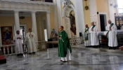 Archbishop Roberto Gonzalez prays with other priests during Sunday Mass in the San Juan Cathedral in San Juan, Puerto Rico, on Oct. 1, 2017.