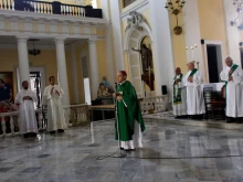 Archbishop Roberto Gonzalez prays with other priests during Sunday Mass in the San Juan Cathedral in San Juan, Puerto Rico, on Oct. 1, 2017.