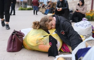 A girl sleeps in a street in the town of Stepanakert on Sept. 25, 2023. Ethnic Armenian refugees began to leave Nagorno-Karabakh on Sept. 24, 2023, for the first time since Azerbaijan launched an offensive designed to seize control of the breakaway territory and perhaps end a three-decade-old conflict. Credit: HASMIK KHACHATRYAN/AFP via Getty Images