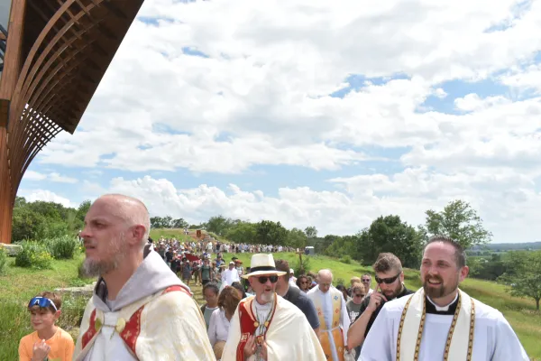 The Eucharistic procession reaches the Holy Family Shrine, led by Bishop James Conley (center), as participants follow along the pathway around the shrine on June 21, 2024. Credit: Kate Quiñones/CNA