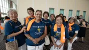 Big smiles from a group from the Diocese of Sacramento, California, as they wait in the long line to complete their registration for the congress in the Indiana Convention Center on July 15, 2024.