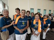 Big smiles from a group from the Diocese of Sacramento, California, as they wait in the long line to complete their registration for the congress in the Indiana Convention Center on July 15, 2024.