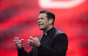 Father Mike Schmitz speaks at the revival session of the National Eucharistic Congress at Lucas Oil Stadium in Indianapolis on July 18, 2024. Credit: Jeffrey Bruno