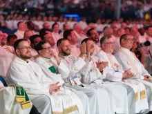 Priests respond to a talk at the National Eucharistic Congress in Indianapolis on July 18, 2024.
