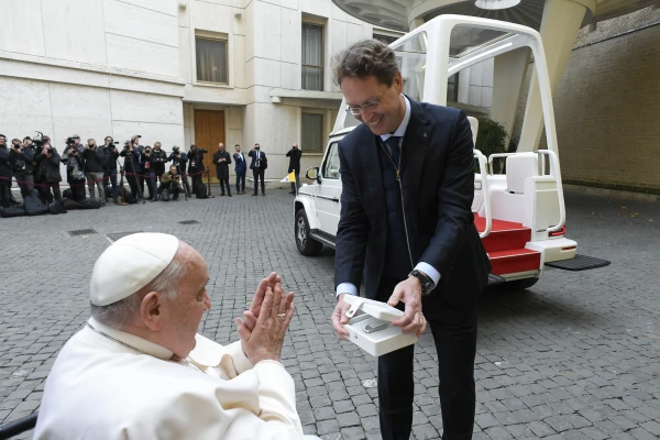 Pope Francis is presented with the key to the new popemobile, an electric Mercedes, on Dec. 4, 2024, at the Vatican. Credit: Vatican Media