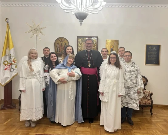 Archbishop Visvaldas Kubokas with local Catholics who put on a live Nativity scene at the nunciature. Credit: Courtesy of the apostolic nuncio