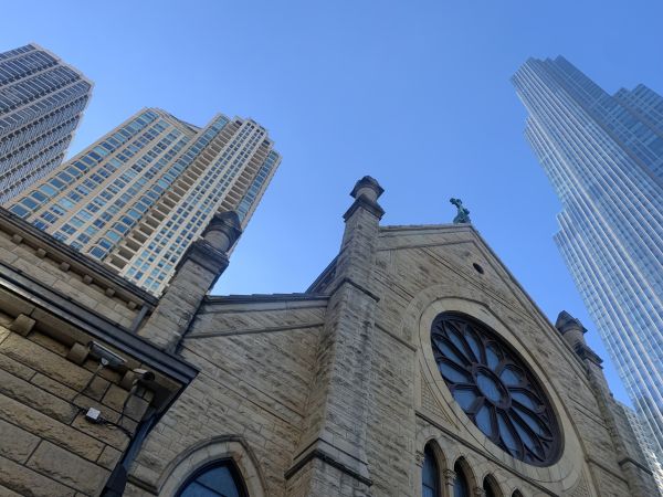 Holy Name Cathedral in Chicago with One Chicago Square in the background, a residential tower constructed on the former cathedral parking lot, which was sold in 2019. Credit: Photo courtesy of Maddy Johnson/Church Properties Initiative