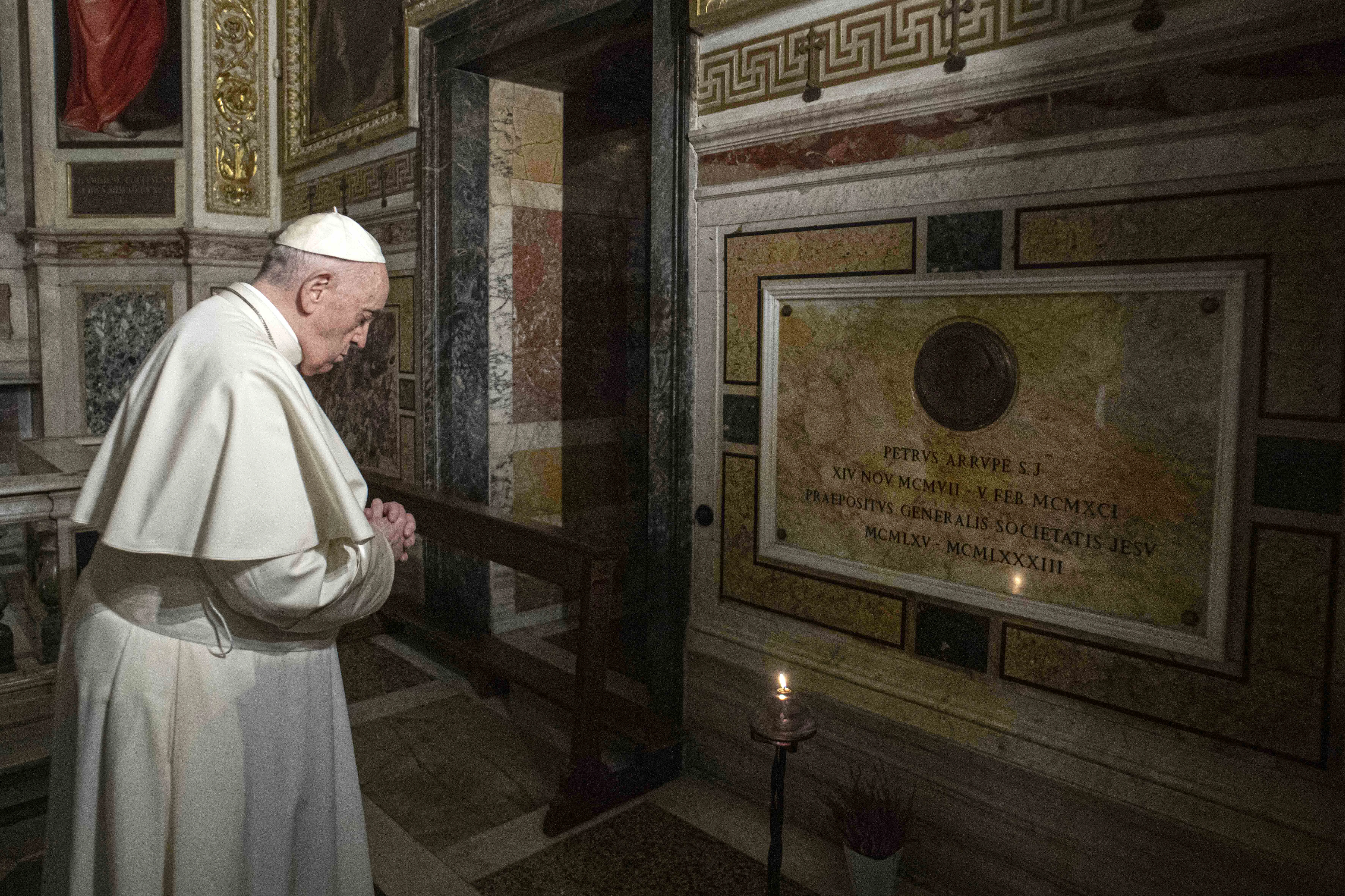 Pope Francis prays near the tomb of Father Pedro Arrupe, SJ, superior general of the Society of Jesus between 1965 and 1981, during a Mass at the Jesuit Church of the Most Holy Name of Jesus, known as the “Gesu” in Rome, Italy, on March 12, 2022, on the 400th anniversary of the canonization of St. Ignatius of Loyola, the society’s founder.?w=200&h=150