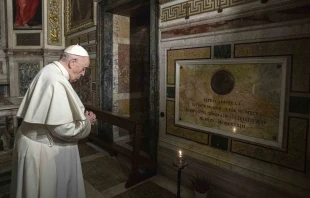 Pope Francis prays near the tomb of Father Pedro Arrupe, SJ, superior general of the Society of Jesus between 1965 and 1981, during a Mass at the Jesuit Church of the Most Holy Name of Jesus, known as the “Gesu” in Rome, Italy, on March 12, 2022, on the 400th anniversary of the canonization of St. Ignatius of Loyola, the society’s founder. Credit: Vatican Media/Abaca/Sipa USA/Sipa via AP Images