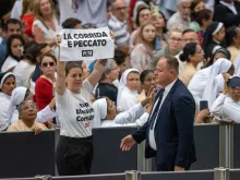 An activist from PETA (People for the Ethical Treatment of Animals) holds a sign that reads “la corrida e peccato” (“bullfighting is a sin”), temporarily interrupted Pope Francis’ catechesis during his Wednesday general audience on Aug. 7, 2024.