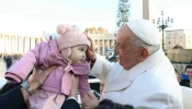 Pope Francis blessing a baby during a general audience.