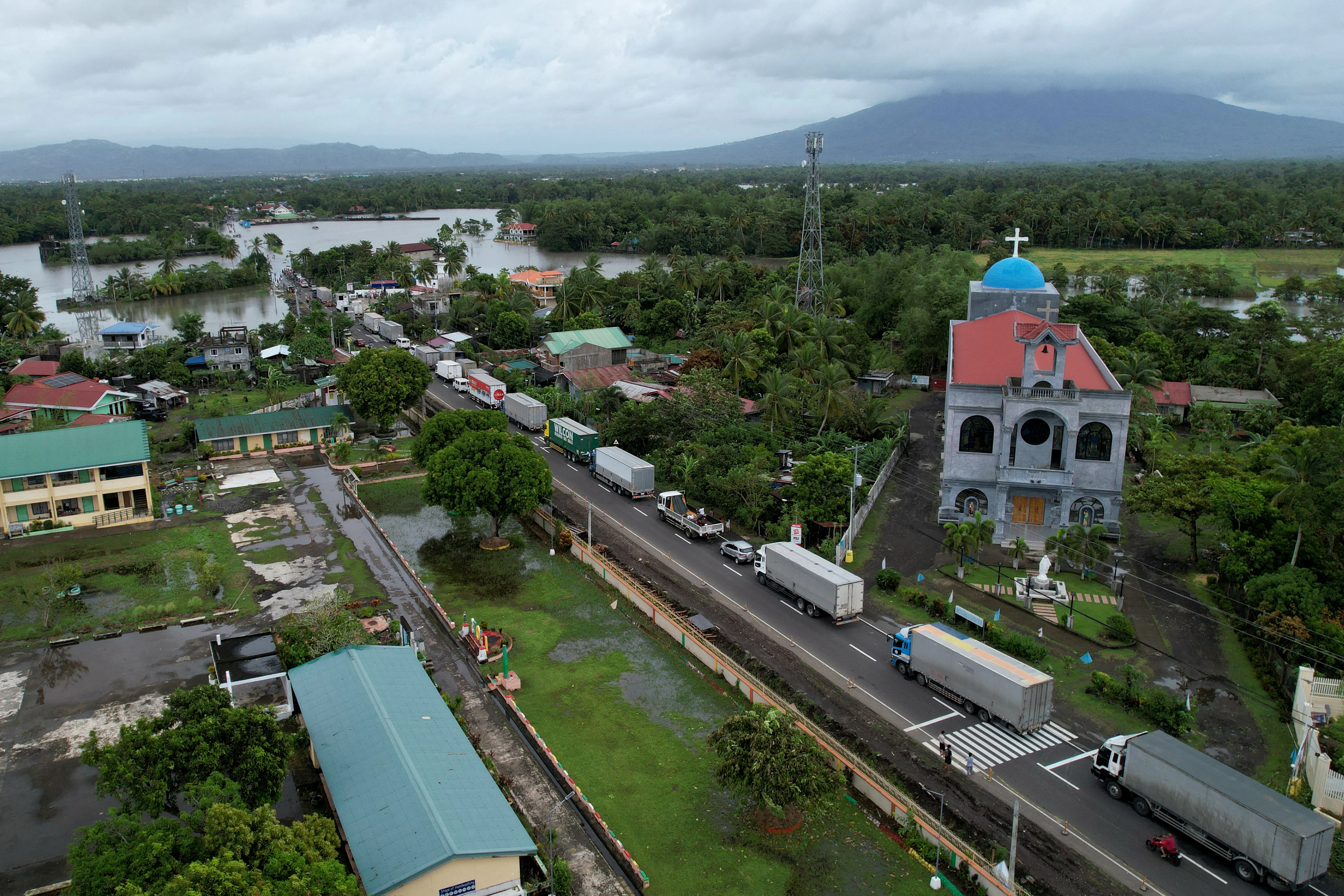 An aerial view shows a long line of trucks stranded along a flooded highway caused by heavy rains brought about by Tropical Storm Trami in Nabua town, Camarines Sur province, South of Manila, Philippines, on Oct. 23, 2024.?w=200&h=150