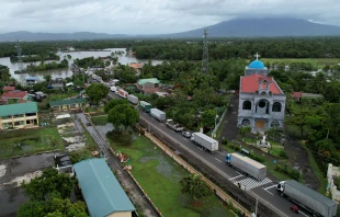 An aerial view shows a long line of trucks stranded along a flooded highway caused by heavy rains brought about by Tropical Storm Trami in Nabua town, Camarines Sur province, South of Manila, Philippines, on Oct. 23, 2024. Credit: CHARISM SAYAT/AFP via Getty Images