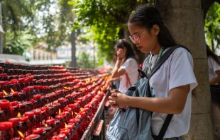 A girl praying at the Basilica del Santo Niño in Cebu, Philippines in 2019. Shutterstock