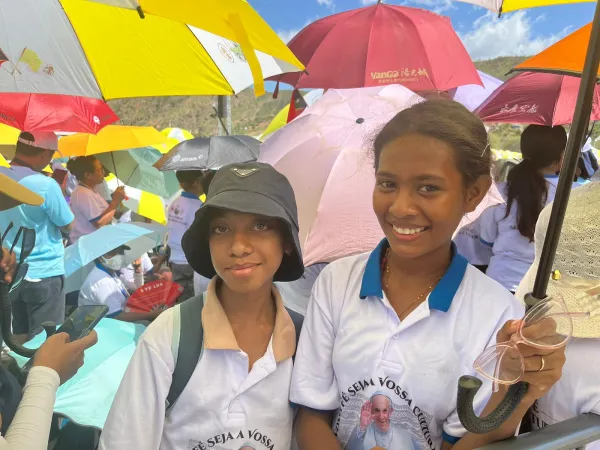 Best friends Lareina Rosa Marcia Claver Da Cruz (left) and Zuizina Abigael Maria Fatima de Jesus attend Mass at the Esplanade of Taci Tolu in Dili, Timor-Leste, Tuesday, Sept. 10, 2024. Credit: Courtney Mares/CNA