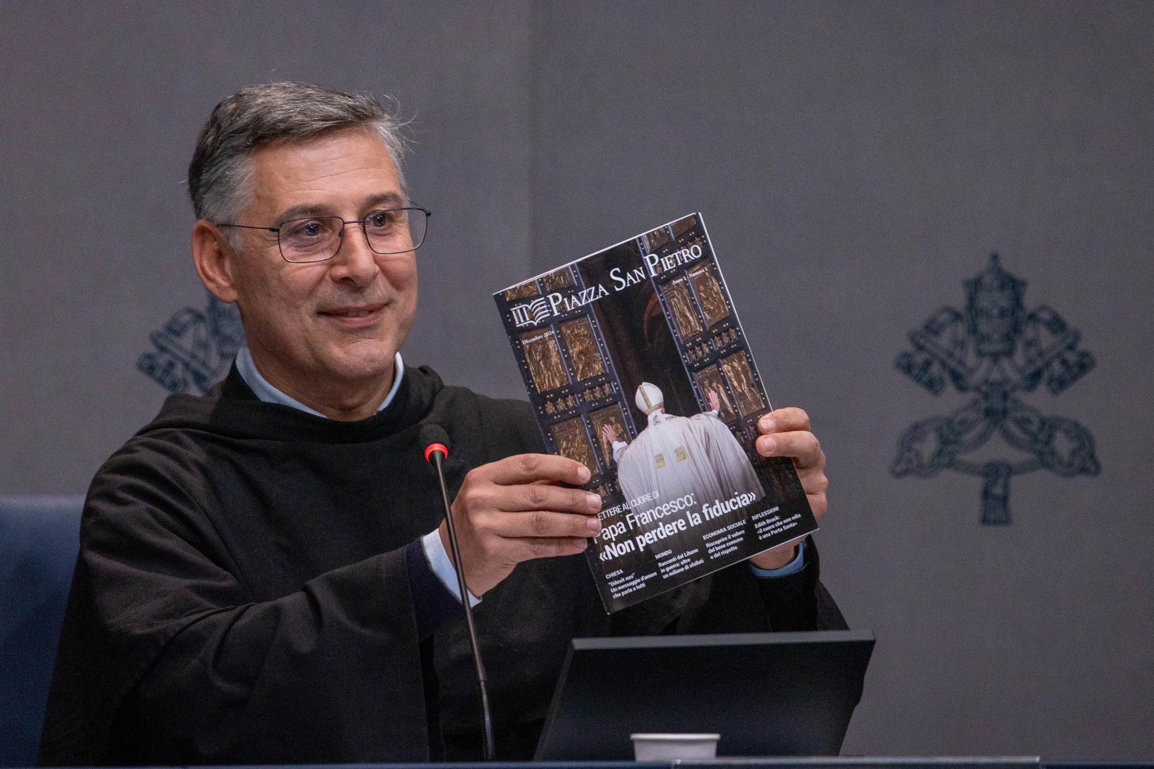 Father Enzo Fortunato, OFM Conv., communications director for St. Peter’s Basilica, holds up a copy of the first issue of the Vatican's new monthly magazine, “Piazza San Pietro.”?w=200&h=150