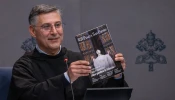 Father Enzo Fortunato, OFM Conv., communications director for St. Peter’s Basilica, holds up a copy of the first issue of the Vatican's new monthly magazine, “Piazza San Pietro.”