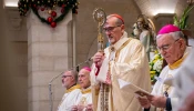 Cardinal Pierbattista Pizzaballa, Latin patriarch of Jerusalem, leans on his pastoral staff while listening to the proclamation of the Gospel during the Christmas Eve Mass at the Church of St. Catherine, the Latin section of the Basilica of the Nativity, on Dec. 24, 2024.