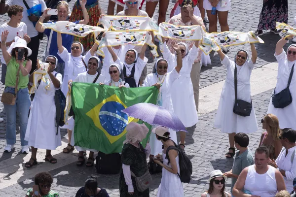 Religious sisters and pilgrims wave flags while Pope Francis gave the Angelus in St. Petter's Square on Aug. 18, 2024. Credit: Vatican Media