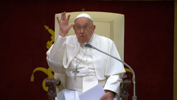 Pope Francis opens his remarks to a group of comedians and humorists by making a silly hand gesture during a gathering at the Vatican's Apostolic Palace on June 14, 2024. Credit: Screenshot of closed-circuit television feed