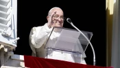 Pope Francis waves to pilgrims gathered in St. Peter’s Square from his window in the Apostolic Palace during his Angelus address on the solemnity of All Saints, Nov. 1, 2024.