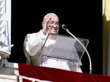 Pope Francis waves to pilgrims gathered in St. Peter’s Square from his window in the Apostolic Palace during his Angelus address on the solemnity of All Saints, Nov. 1, 2024.