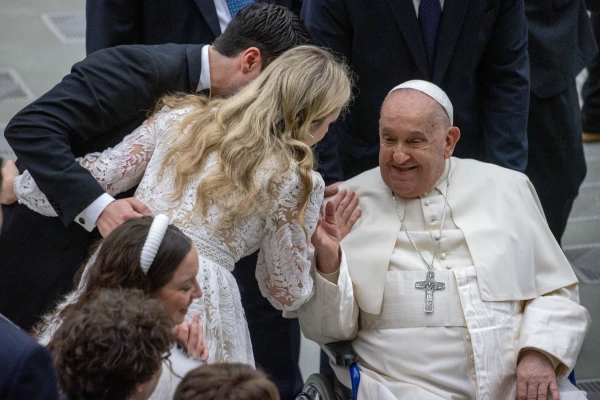 Pope Francis blesses a newly married couple at his general audience on Wednesday, Jan. 8, 2025, in Paul VI Hall at the Vatican. Credit: Daniel Ibañez/CNA