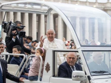 Pope Francis waves to the crowds gathered in St. Peter’ Square as he arrives for his general audience on Wednesday, Oct. 23, 2024, at the Vatican.