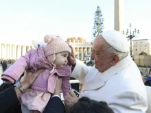 Pope Francis blesses a toddler during his general audience on Wednesday, Dec. 4, 2024, in St. Peter’s Square.