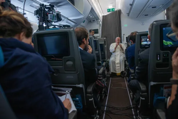 Pope Francis speaks to journalists aboard the papal plane during an in-flight press conference on Friday, Sept. 13, 2024, on his return from his nearly two-week tour of Southeast Asia. Credit: Daniel Ibañez/CNA