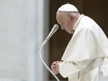 Pope Francis prays during his general audience on Wednesday, May 1, 2024, in Paul VI Hall at the Vatican.