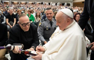 Pope Francis signs two bottles of bourbon presented to him by Father Jim Sichko at the Vatican on May 1, 2024. Credit: Courtesy of Sotheby’s