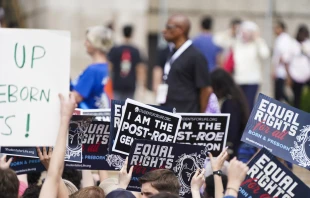 Participants in a pro-life rally hold signs in front of the Lincoln Memorial in Washington, D.C., on June 24, 2023, at a rally marking the first anniversary of the Supreme Court's Dobbs decision that overturned Roe v. Wade. Credit: Joseph Portolano/CNA