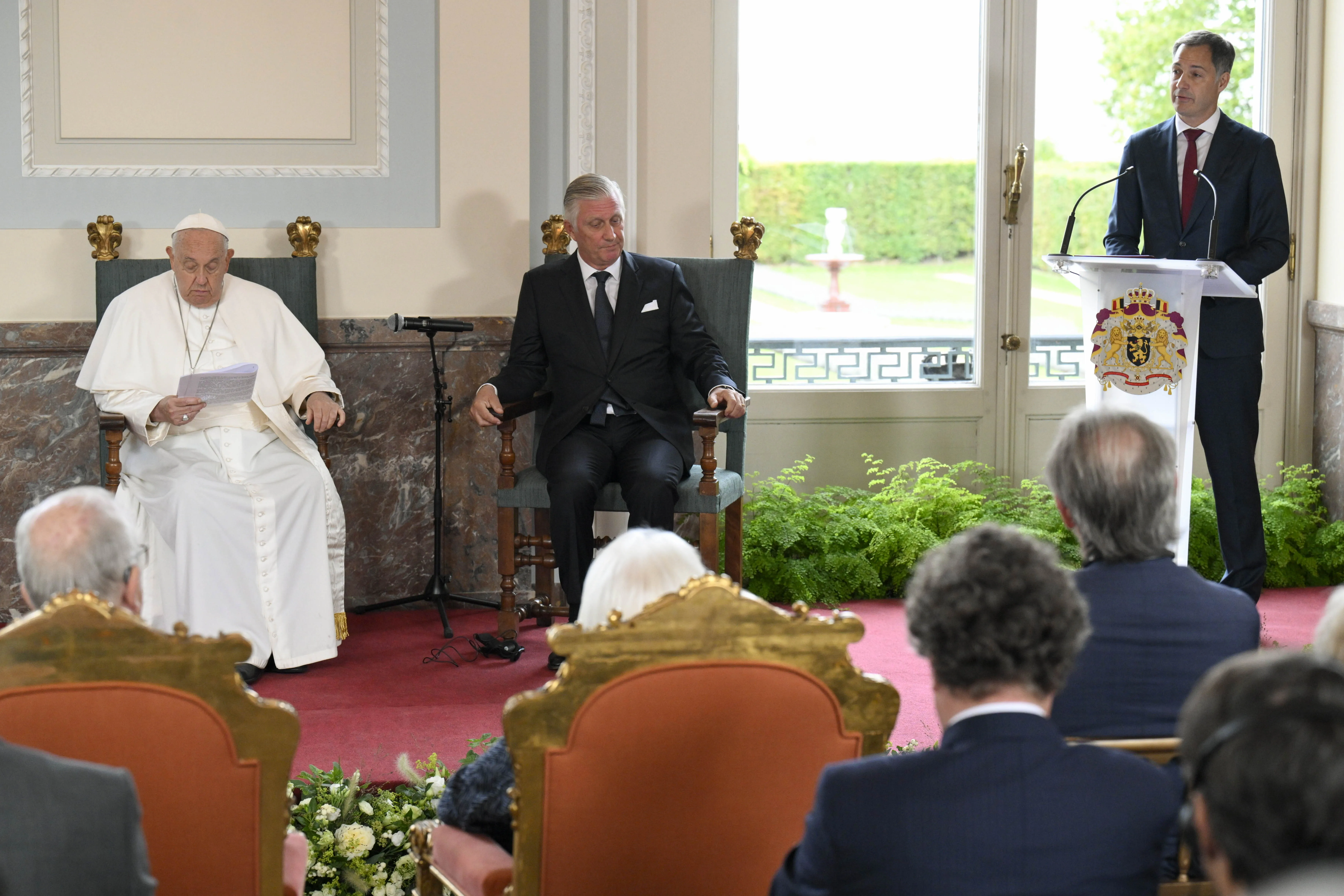 Pope Francis and King Philippe listen to a speech by Belgium Prime Minister Alexander De Croo during the pope's trip to Belgium in late September 2024.