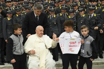 Pope Francis greets pilgrims and poses for photos at the end of his general audience on Nov. 29, 2023.