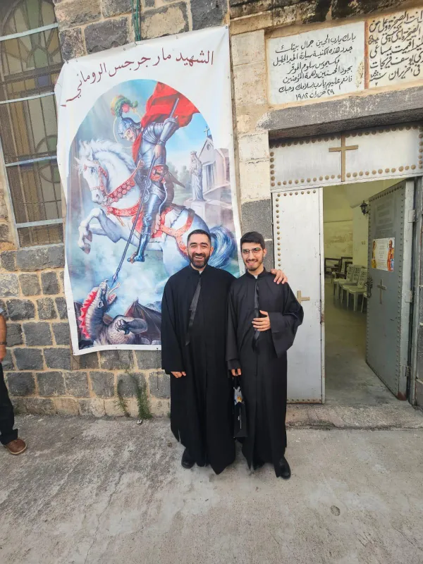 Father Rody Noura, on the left, with Father Giovanni Bovi, a recently ordained priest serving in the Maronite Church, outside the church in Tiberias. Noura was 13 years old when he fled from Lebanon to Israel. “I wondered: Why did all this happen to me? I’m just a child. I wanted to escape from this world; I had lost trust in everyone, even myself.” Then came an encounter with the Neocatechumenal Way and the message that “God exists and loves me as I am. It was the answer I was looking for. It restored my hope.” Credit: Photo courtesy of Father Rody Noura