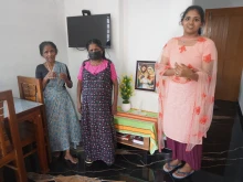 A family gathers in a prefabricated house donated by the Philokalia Foundation in Kerala state in India.