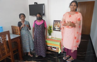 A family gathers in a prefabricated house donated by the Philokalia Foundation in Kerala state in India. Credit: Anto Akkara